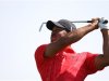 Woods of the U.S. watches his shot from the seventh tee during the final round of the Abu Dhabi Championship at the Abu Dhabi Golf Club