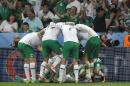 Ireland's players celebrate after Robbie Brady scored, during the Euro 2016 Group E soccer match between Italy and Ireland at the Pierre Mauroy stadium in Villeneuve d'Ascq, near Lille, France, Wednesday, June 22, 2016. (AP Photo/Antonio Calanni)