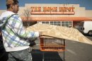 Customer loads lumber into his car after shopping at a Home Depot location in Washington
