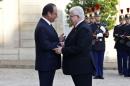 France's President Francois Hollande, left, talks with Iraqi counterpart Fouad Massoum ahead of a conference with U.S. Secretary of State John Kerry, French President Francois Hollande and diplomats from around the world, at the Elysee Palace, in Paris, Monday, Sept. 15, 2014. (AP Photo/Thibault Camus)