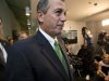 Speaker of the House John Boehner, R-Ohio, passes waiting reporters as he leaves a closed-door GOP meeting on the "fiscal cliff" bill passed by the Senate Monday night, at the Capitol in Washington, Tuesday, Jan. 1, 2013.  (AP Photo/J. Scott Applewhite)