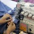 A Bangladeshi garment factory worker operates a machine at a factory in Dhaka, in 2009