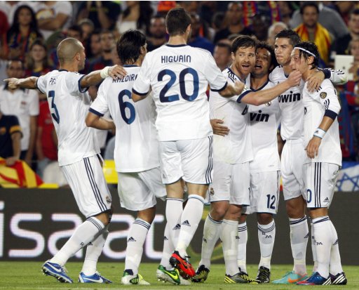 Real Madrid's Ronaldo celebrates with teammates after scoring his second goal against Barcelona during their Spanish first division soccer match at Nou Camp stadium in Barcelona