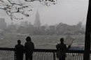 Residents try to watch the skyline of New York from a park along the Hudson River across from the Empire State Building as rain falls in Hoboken while Hurricane Sandy approaches to New Jersey