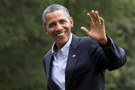 U.S. President Barack Obama waves as he returns to the White House in Washington
