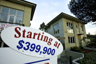 <p>               Newly built luxury townhomes are offered for sale in Woodland Hills, Calif. Tuesday, Jan. 10, 2012. Fixed mortgage rates hit yet another record low on the second week of the new year. But the cheap rates are expected to do little to boost the depressed housing market. (AP Photo/Damian Dovarganes)
