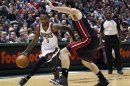 Bucks guard Jennings drives to the basket against Heat center Harrellson in the second half of their NBA basketball game in Milwaukee