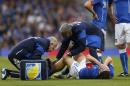 Italy's Riccardo Montolivo, lower right, is being treated after injured from a tackle during their international friendly soccer match against the Republic of Ireland, at Craven Cottage, London, Saturday, May 31, 2014. (AP Photo/Sang Tan)