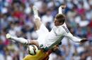 Real Madrid's Toni Kroos, top, duels for the ball with Valencia's Andres Gomes during a Spanish La Liga soccer match at the Santiago Bernabeu stadium in Madrid, Spain, Saturday May 9, 2015. (AP Photo/Oscar del Pozo)
