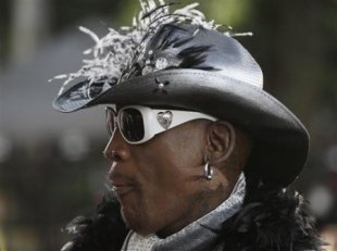 Former Chicago Bulls forward Dennis Rodman arrives at the Basketball Hall of Fame enshrinement ceremony in Springfield, Mass., on Friday night, Aug. 1