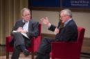 Former President George W. Bush, left, listens to Pulitzer Prize winning author Jon Meacham, right, talk about his biography of Bush's father, former President George H. W. Bush, Sunday, Nov. 8, 2015 at the George W. Bush Presidential Center in Dallas. (AP Photo/Jeffrey McWhorter)