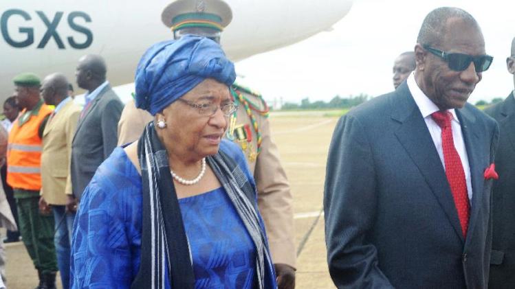 Liberia President Ellen Johnson Sirleaf is welcomed by Guinean counterpart Alpha Conde at Conakry airport on August 1, 2014, prior to the opening of a summit against the fast-growing outbreak of the Ebola virus