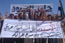 Demonstrators protest against Syria's President Bashar al-Assad after Friday prayers in the northern Syrian city of Hass