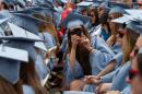 File photo of a graduate from Columbia University's Barnard College taking a photo during the university's commencement ceremony in New York
