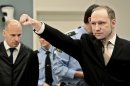 Accused Norwegian Anders Behring Breivik gestures as he arrives at the courtroom, Monday, April 16, 2012 in Oslo, Norway. The terror trial against an anti-Muslim fanatic who confessed to killing 77 people in Norway starts amid worries that he will use the proceedings to showcase his radical views. After opening statements, Breivik is set to testify for five days, explaining why he set off a bomb in downtown Oslo, killing eight, and then shot to death 69 people, mostly teenagers, at a Labor Party youth camp on Utoya island, outside the Norwegian capital.(AP Photo/Hakon Mosvold Larsen, Pool)