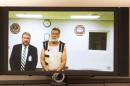 Colorado Springs Planned Parenthood shooting suspect Robert Dear, right, appears via video hearing during his first court appearance, where he was told he faces first degree murder charges, Monday, Nov. 30, 2015, in Colorado Springs, Colo. At left is public defender Dan King. (Mark Reis/The Gazette via AP, Pool)