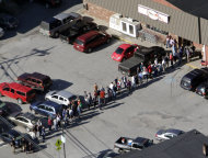 Residents stand in line outside a grocery store on Tuesday, Aug. 30, 2011 in Rochester, Vt. The town has been completely cut off since Tropical Storm Irene hit. (AP Photo/Toby Talbot)