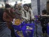 In this Thursday, Jan. 19, 2012 photo, people push their shopping carts at the Kwangbok Area shopping center to buy groceries in Pyongyang, North Korea. (AP Photo/David Guttenfelder)