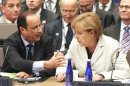 German Chancellor Angela Merkel listens to French President Francois Hollande during the 2012 NATO Summit in Chicago