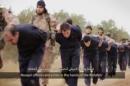 This still image taken from an undated video published on the Internet by the Islamic State group militants and made available, Sunday, Nov. 16, 2014, purports to show extremists marching Syrian soldiers before beheading them. The high-definition video later shows the beheadings of about a dozen men identified as Syrian military officers and pilots, all dressed in blue jumpsuits. The Associated Press could not independently verify the footage, though it appeared on websites used in the past by the Islamic State group, which now controls a third of Syria and Iraq. (AP Photo)