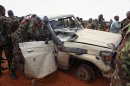 A picture released on August 22, 2013 show AMISOM troops inspecting a destroyed Shebab vehicle at Kismayo Airport