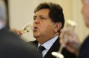 Peru's President Alan Garcia toasts with ministers during his last cabinet meeting at the government palace in Lima