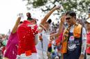 Chella Choi, front left, of South Korea, and her father and caddie Ji Yeon Choi, right, are doused by Mi Hyang Lee, also of South Korea, after winning the Marathon Classic golf tournament on the first playoff hole at Highland Meadows Golf Club in Sylvania, Ohio, Sunday, July 19, 2015. (AP Photo/Rick Osentoski)
