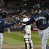 Seattle Mariners' Trayvon Robinson, left, congratulates Alex Liddi after Liddi's solo home run off Minnesota Twins pitcher Liam Hendriks in the sixth inning of a baseball game Tuesday, Sept. 20, 2011 in Minneapolis. (AP Photo/Jim Mone)