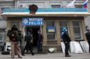 Armed pro-Russian activists guard a police station in the eastern Ukrainian city of Slavyansk after it was seized by a few dozen gunmen on April 12, 2014