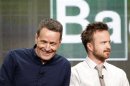 Cranston smiles next to Paul at a panel for the television series "Breaking Bad" during the AMC portion of the Television Critics Association Summer press tour in Beverly Hills