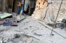 A man inspects damage outside a field hospital after an airstrike in the rebel-held al-Maadi neighbourhood of Aleppo
