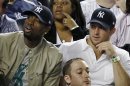 Miami Heat's Dwayne Wade, left, sits beside New York Jets quarterback Tim Tebow during the New York Yankees baseball game against the Los Angeles Angels at Yankee Stadium in New York, Sunday, April 15, 2012. (AP Photo/Kathy Willens)