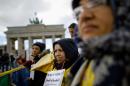Supporters of the National Council of Resistance of Iran attend a hunger strike in protest against the situation in the Ashraf and Liberty Camps near Baghdad, in front of the Brandenburg Gate in Berlin, Germany Friday, Oct. 18, 2013. (AP Photo/Markus Schreiber)