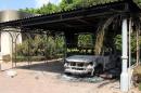 The wreckage of a car sits inside the US Embassy compound on September 12, 2012 in Benghazi, Libya, following an overnight attack on the building