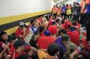 Chilean fans are surrounded by security personnel after breaking into Maracana Stadium before the group B World Cup soccer match between Spain and Chile in Rio de Janeiro, Brazil, Wednesday, June 18, 2014. (AP Photo/Bernat Armangue)