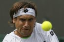 David Ferrer of Spain hits a return to Ivan Dodig of Croatia in their men's singles tennis match at the Wimbledon Tennis Championships, in London