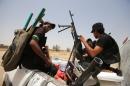 Iraqi Shiite fighters from the Popular Mobilisation units drive through the city of Baiji, north of Tikrit, as they fight alongside Iraqi forces against the Islamic State group