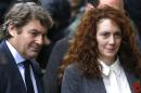 Rebekah Brooks and her husband Charlie Brooks arrive at The Old Bailey law court in London, Thursday, Oct. 31, 2013. Former News of the World national newspaper editors Rebekah Brooks and Andy Coulson went on trial Monday, along with several others, on charges relating to the hacking of phones and bribing officials while they were employed at the now closed tabloid paper. (AP Photo/Kirsty Wigglesworth)