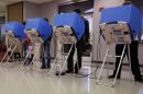 Adams County, Colorado voters casts their vote at a polling place in the Thornton Recreation Center, Tuesday, Nov. 4, 2014, in Thornton, Colo. (AP Photo/Jack Dempsey)