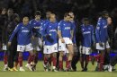 The Portsmouth players walk off the pitch after their English Premier League soccer match against Sunderland in Portsmouth