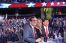 An August 6, 2015 photo shows presidential primary debate moderator Megyn Kelly (C) flanked by fellow moderators Chris Wallace (L) and Bret Baier (R)
