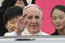 Pope Francis waves upon his arrival at Seoul Air Base as South Korean President Park Geun-hye, left, smiles in Seongnam, South Korea, Thursday, Aug. 14, 2014. Pope Francis arrived here on a visit meant to beatify 124 Korean martyrs and encourage the faithful in a church seen as a model for the future of Catholicism. (AP Photo/Ahn Young-joon, Pool)