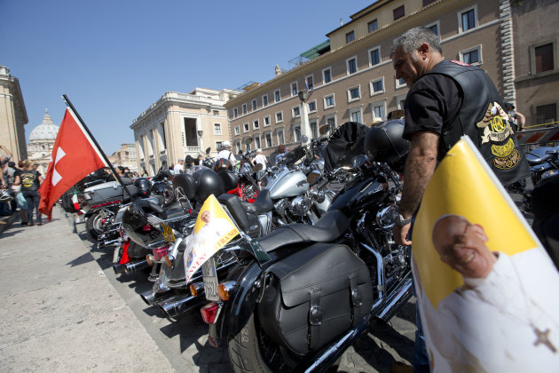 Harley Davidson motorcycles riders park their motorcycles in Via della Conciliazione leading to the Vatican, seen at left, as they wait for Pope Francis to drive by to bless them ahead of mass in St. Peter's Square, at the Vatican, Sunday, June 16, 2013. The riders are gathered in Rome for a four-day event to celebrate the motorcycle company's 110th anniversary. (AP Photo/Andrew Medichini)