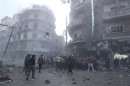 Civilans and Free Syrian Army fighters gather at the site hit by a missile in Aleppo's al-Mashhad district