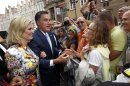 U.S. Republican presidential candidate Mitt Romney and his wife Ann meet people on the street before his meeting with Poland's Prime Minister Donald Tusk at the Old Town Hall in Gdansk
