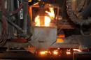 In this May 12, 2014 photo, molten metal is cast at Rochester Metal Products Corp. in Rochester, Ind. The hulking induction furnaces the plant uses to melt scrap iron consume enough electricity to power 7,000 households. (AP Photo/AJ Mast)
