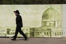 An ultra-Orthodox Jewish man walks past a sign depicting the Dome of the Rock Mosque, in Jerusalem, Sunday, May 19, 2013. (AP Photo/Sebastian Scheiner)