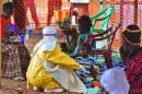 An medical worker feeds an Ebola child victim at an Medecins Sans Frontieres facility in Kailahun, Sierra Leone, on August 15, 2014