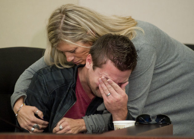 GRESHAM, OREGON - October 18, 2012 - Clint Heichel gets a hug from Lorilei Ritmiller, mother of Whitney Heichel, as he breaks down after he attempted to speak at a news conference Thursday Oct. 18, 2012 in the council chambers for the City of Gresham. (AP Photo/Brent Wojahn, The Oregonian)