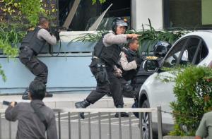 Indonesian police take position and aim their weapons&nbsp;&hellip;